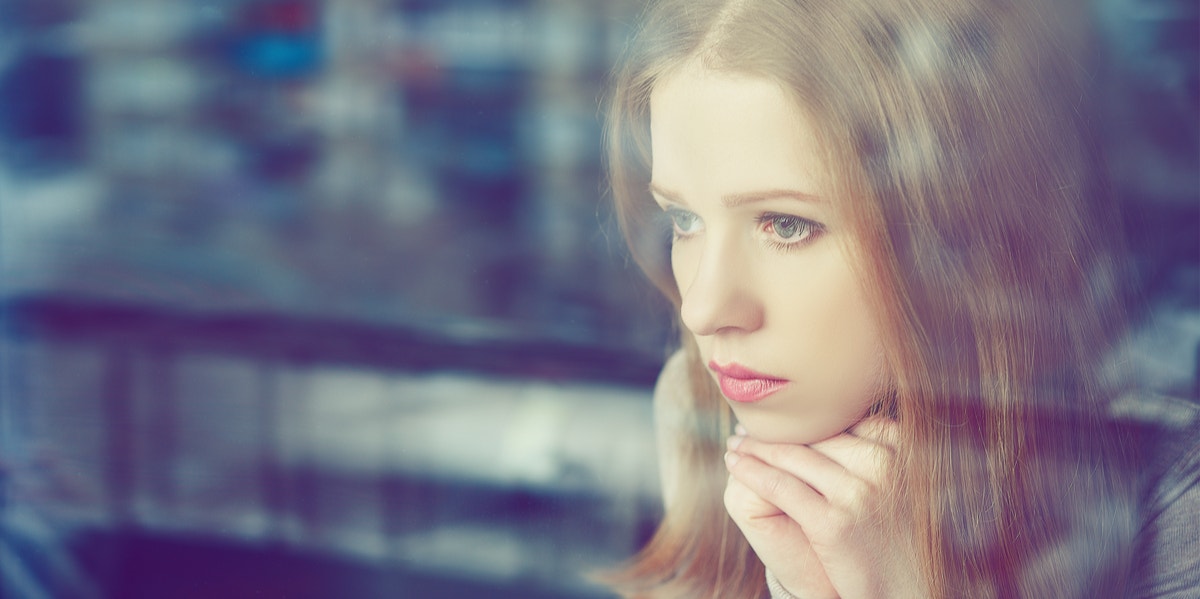 woman looking out window