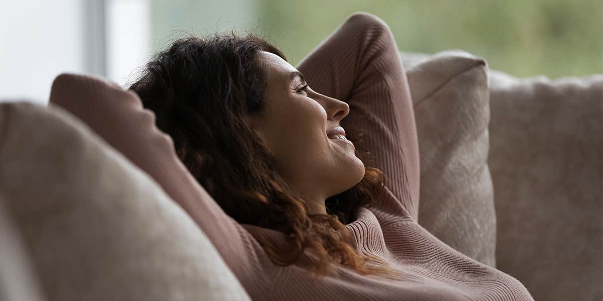 I Was Grateful When She Called Me a Thief and Ended Our Friendship woman smiling relaxing on couch