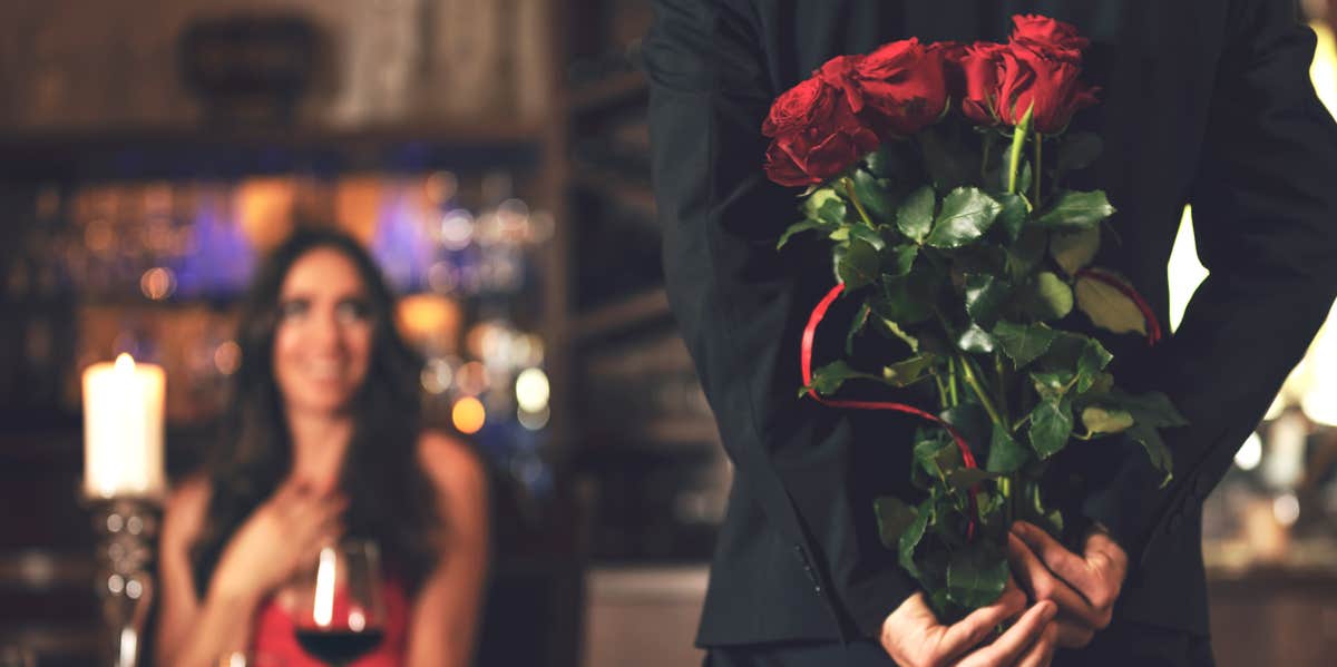 man presenting roses to a woman