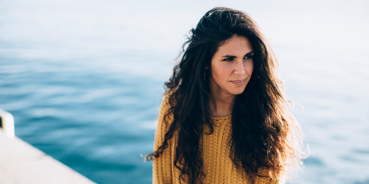 woman sitting by water