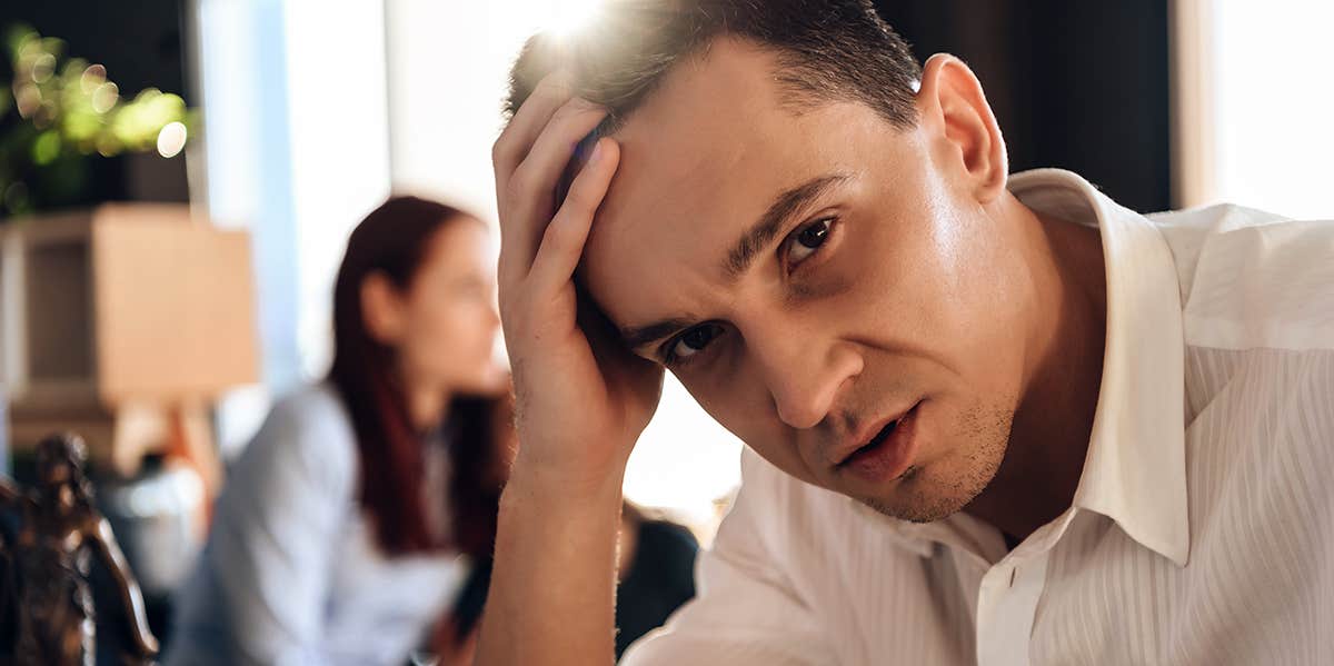 I Feared My Controlling Husband Would Harm Me If He Didn't Get All the Money In Our Divorce abusive husband with wife behind him going through divorce