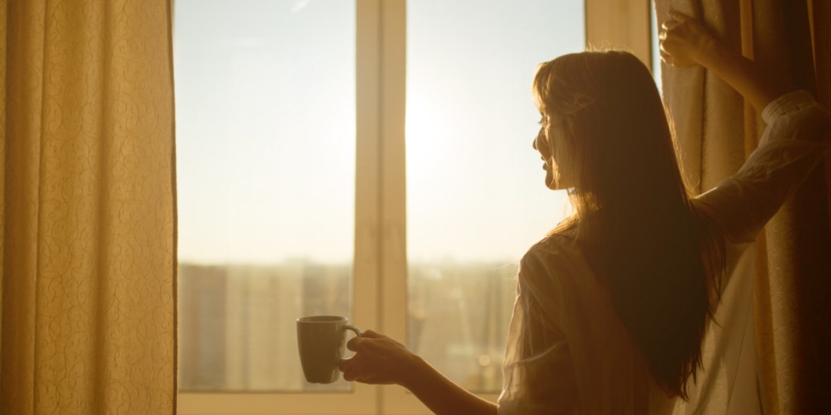 woman looking out her window