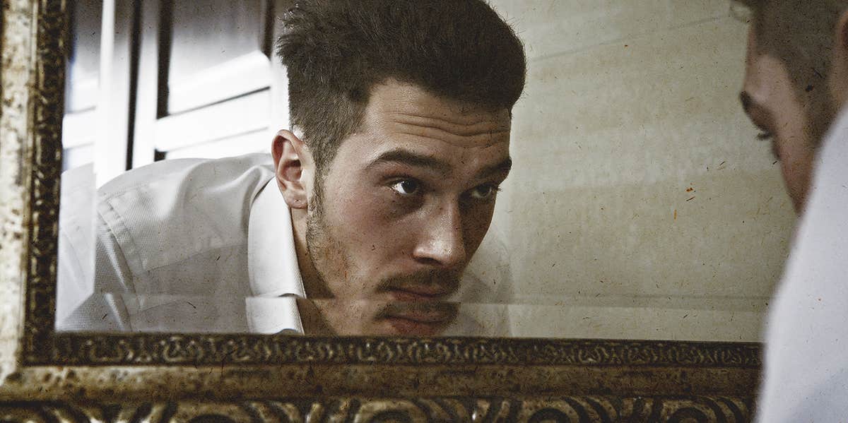 How To Immediately Tell If A Guy Is Emotionally Unavailable man looking at a mirror