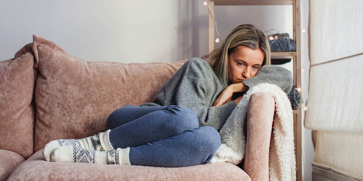 If He Does These 3 Things, Sorry Girl — He's Gonna Cheat On You sad woman on couch