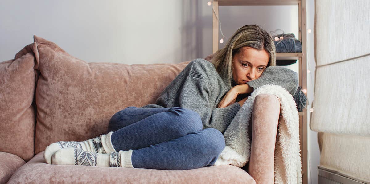 sad woman on couch