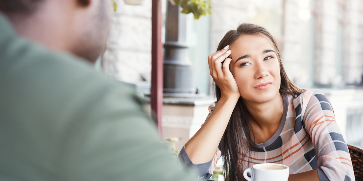 unhappy woman looking at a man across a table