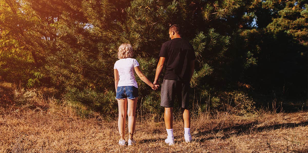 tall guy holding hands with short girl