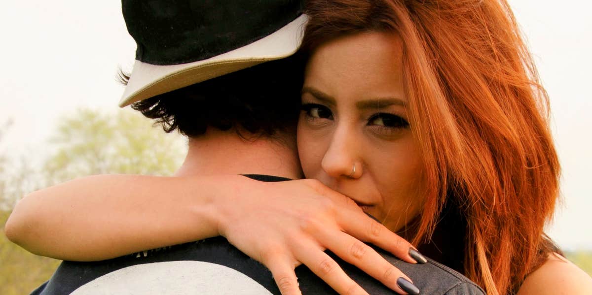 Signs you're with your partner for the wrong reasons woman hugging boyfriend