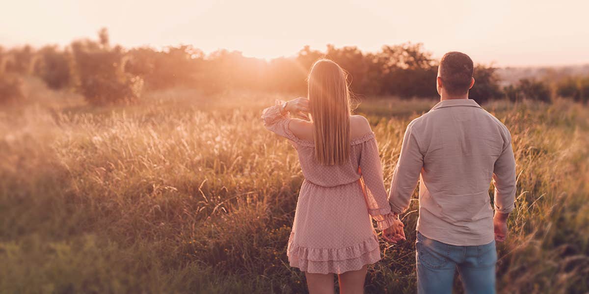 10 Unsexy Signs It's Lasting Love couple holding hands in the wild