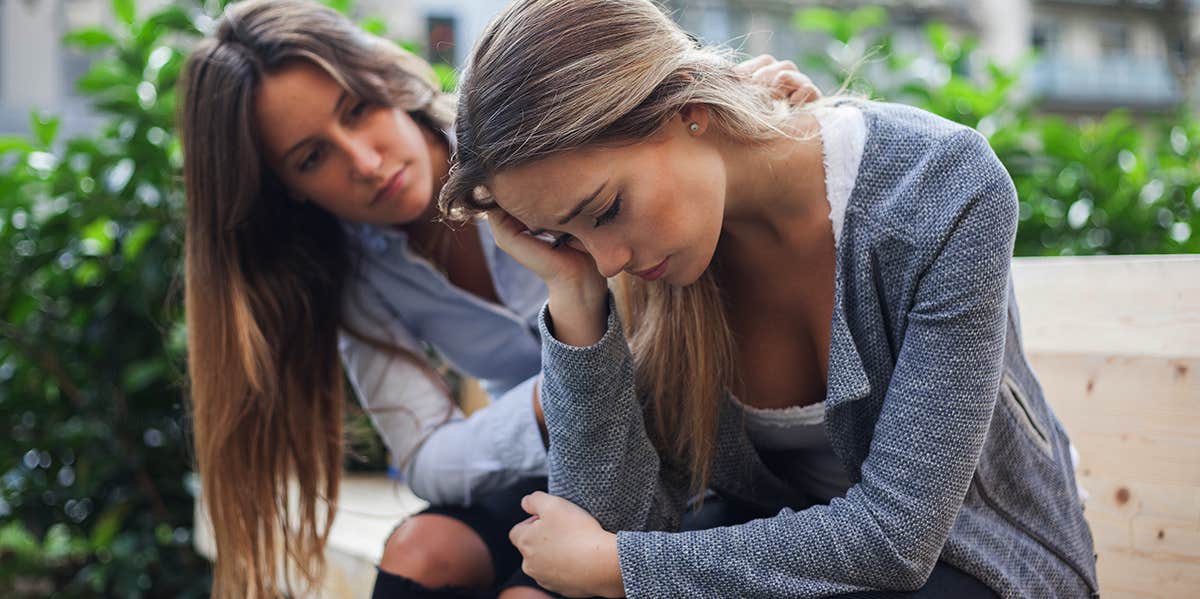 woman trying to comfort sad friend