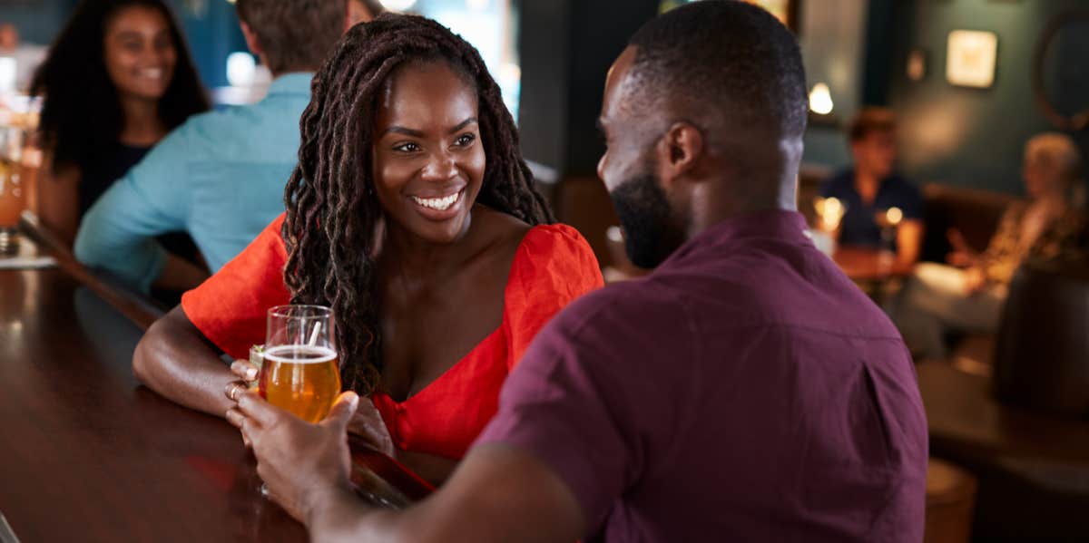 man flirting with woman at bar