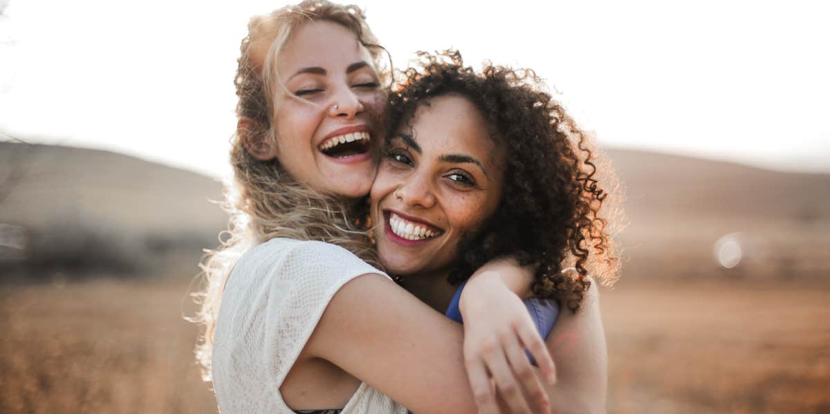 two mom friends embracing