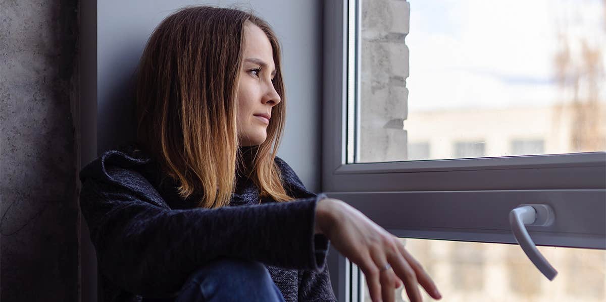 sad woman looking out window