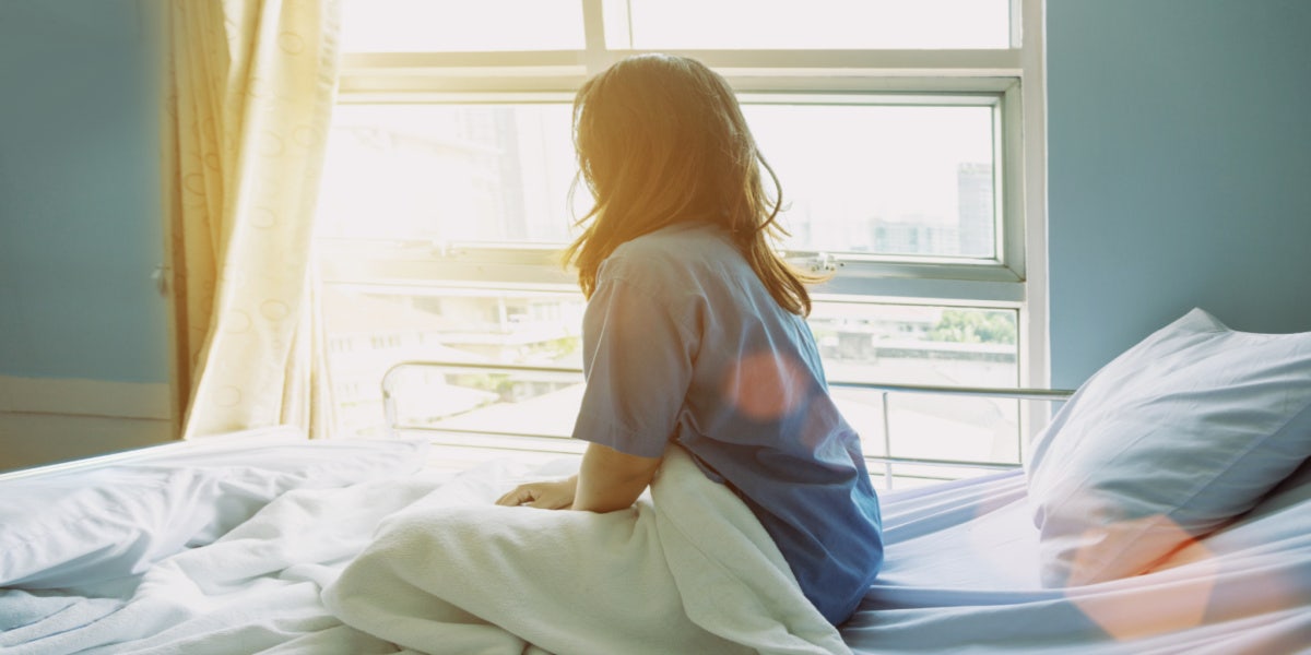 woman sitting in hospital bed