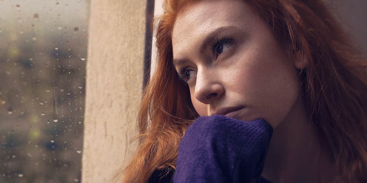 woman leaning against the window