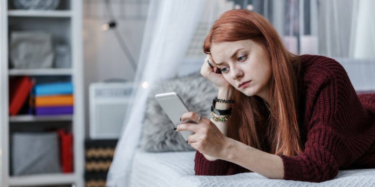 mad woman looking at phone 