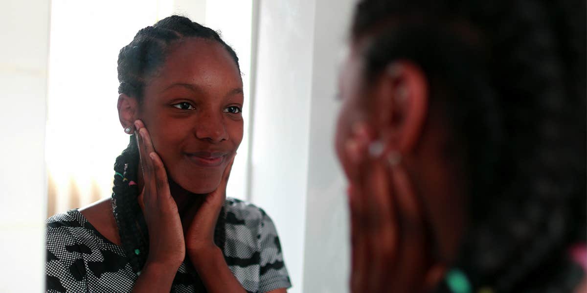 I’m Not Perfect But I Can Finally See The Beauty In Myself woman smiling in the mirror