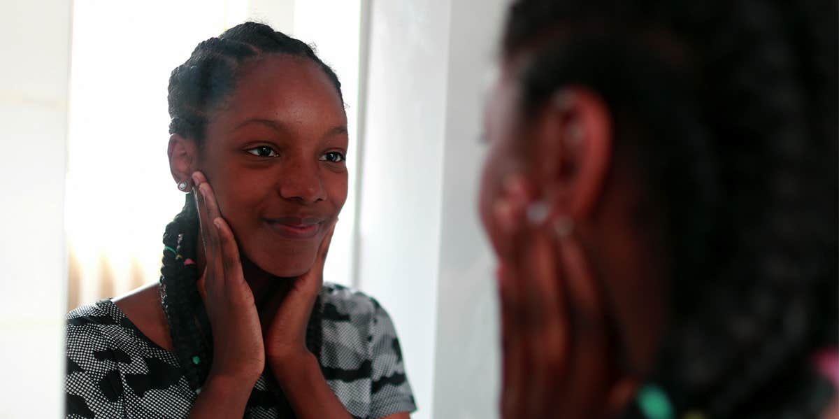 woman smiling in the mirror