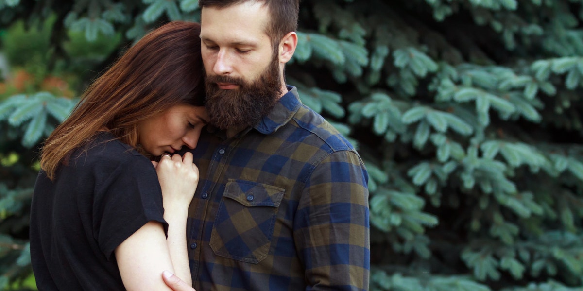 man hugging woman