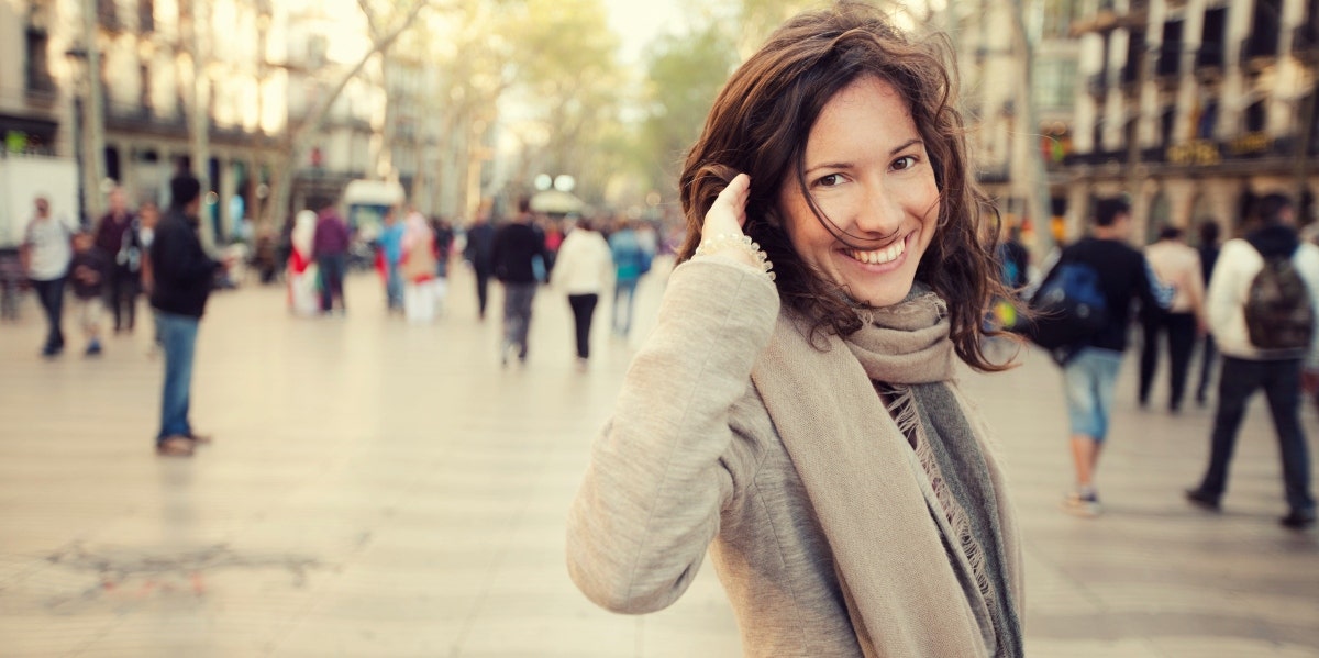 smiling woman in a scarf and sweater