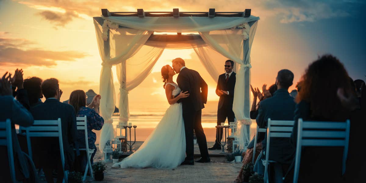 bride and groom during outdoor wedding ceremony on the beach