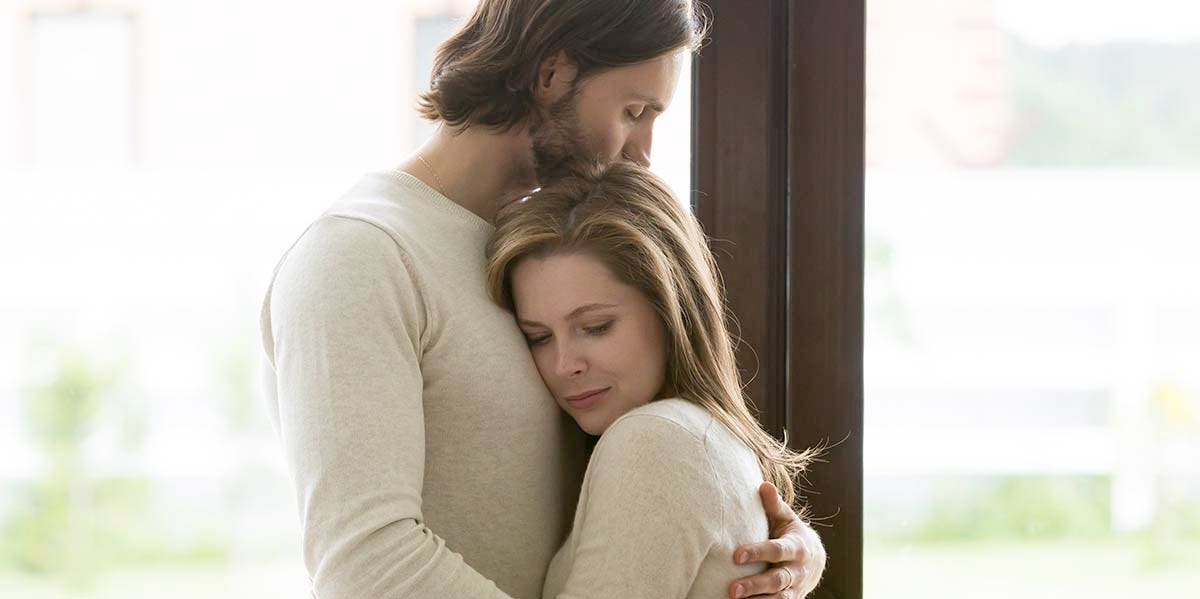 My Wife Is Fertile, I'm Not, And It's Tearing Us Apart husband and wife embracing