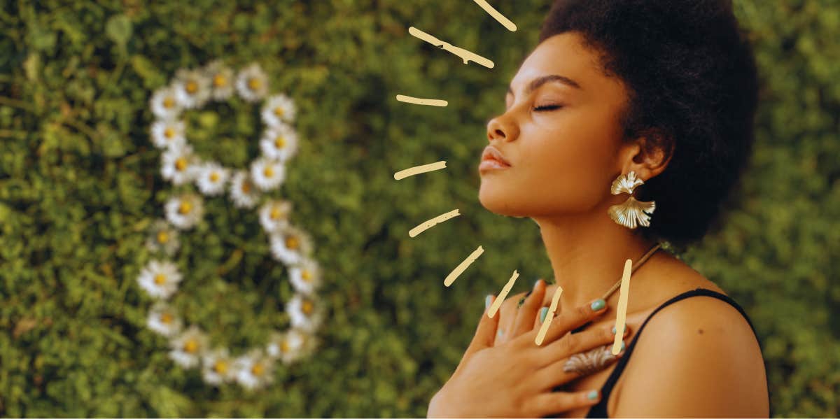 woman meditating with grass and a figure 8 in daisies in the background