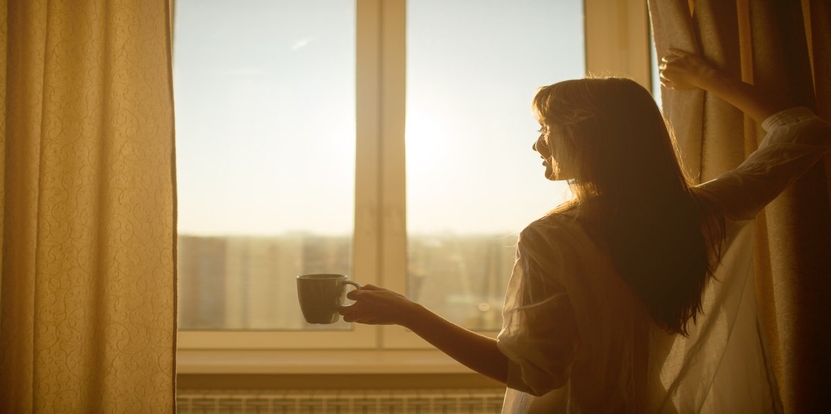 woman looking out window