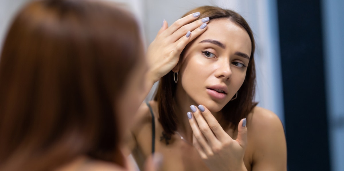 woman looking into a mirror