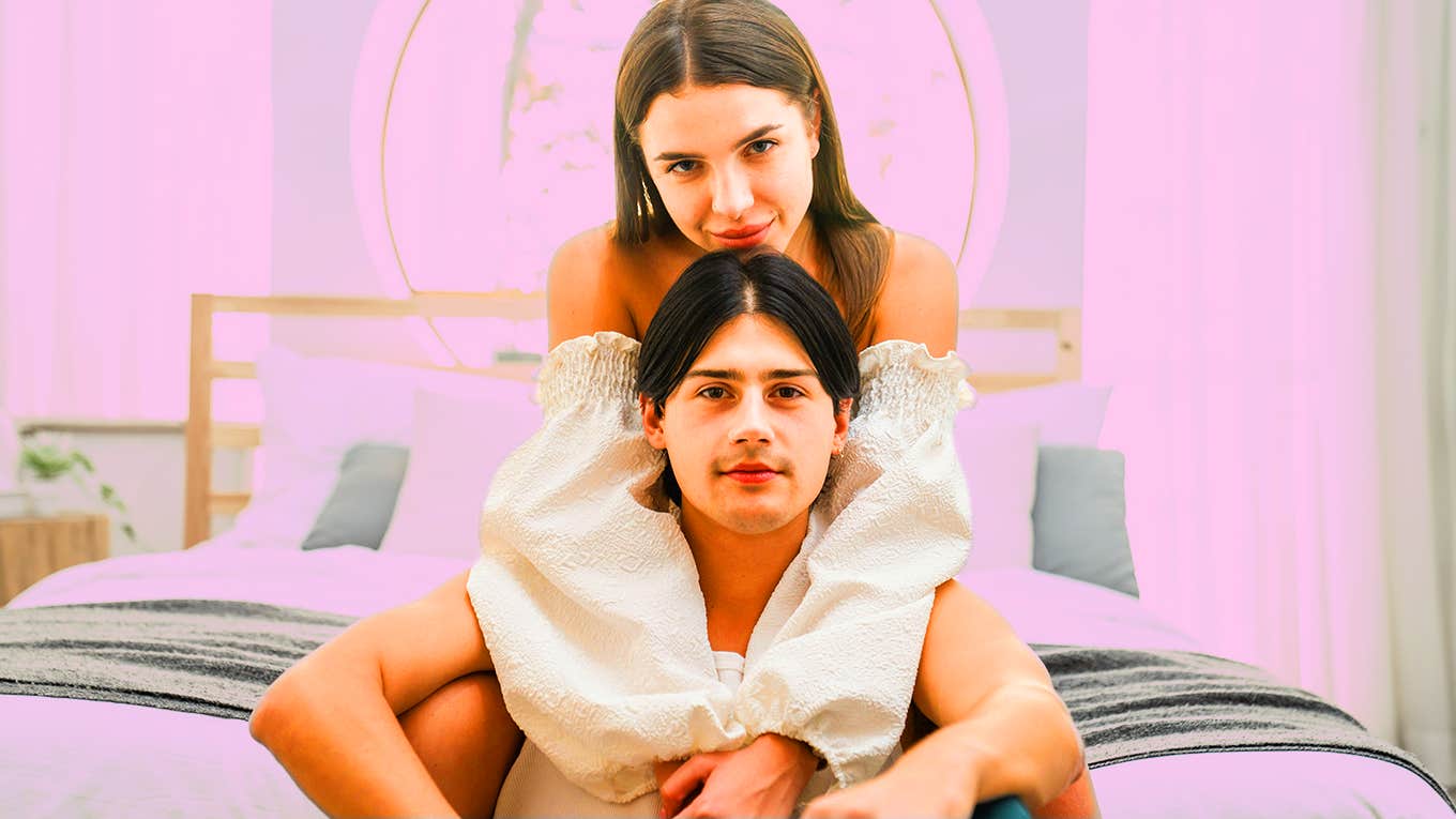 woman and man sitting on bed