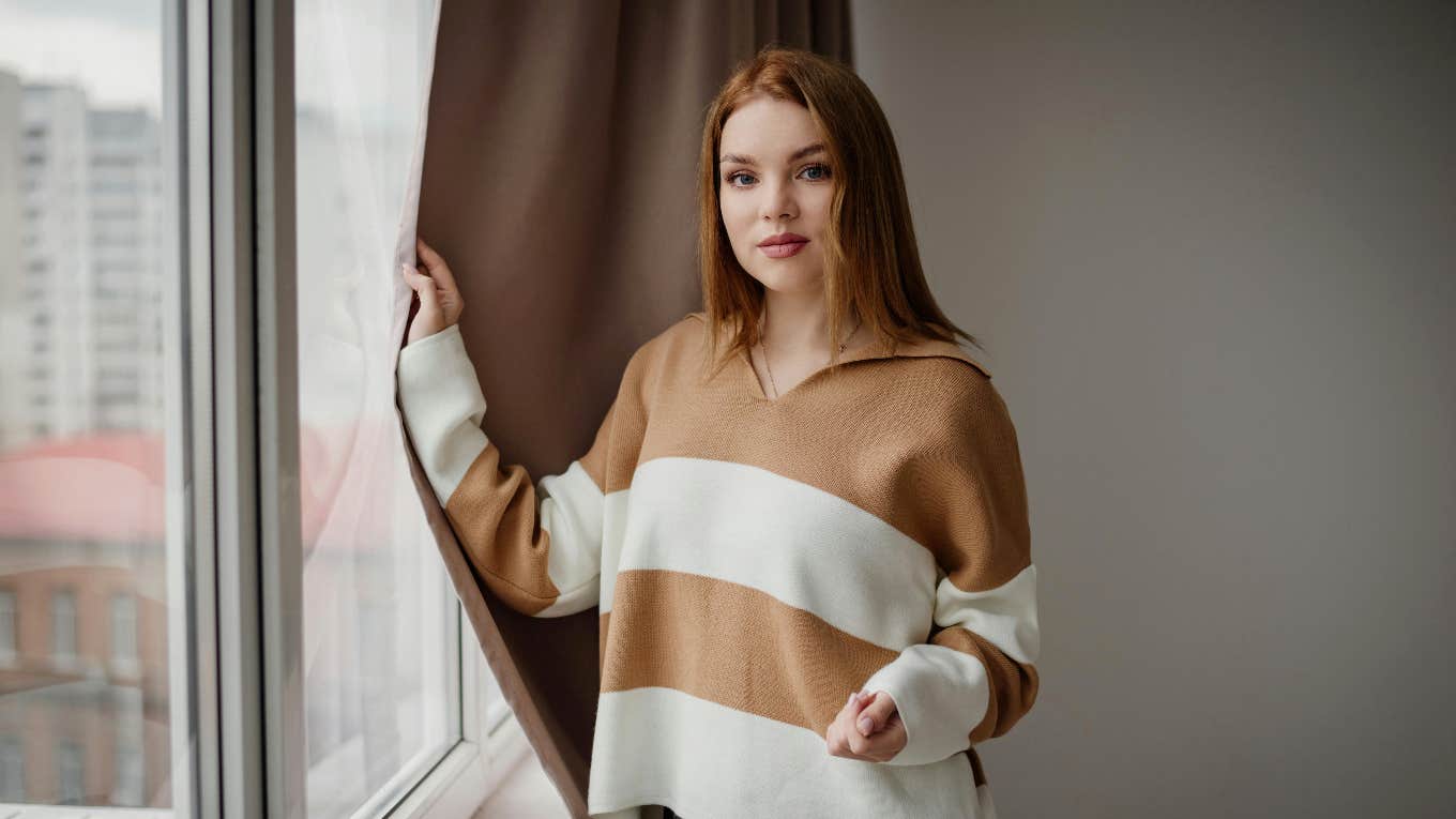 woman in striped sweater at home
