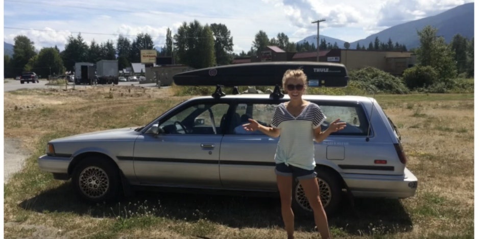 woman standing in front of car