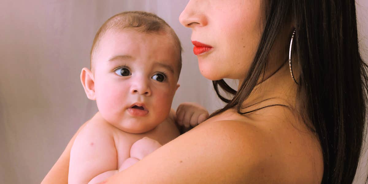 mother holding young baby