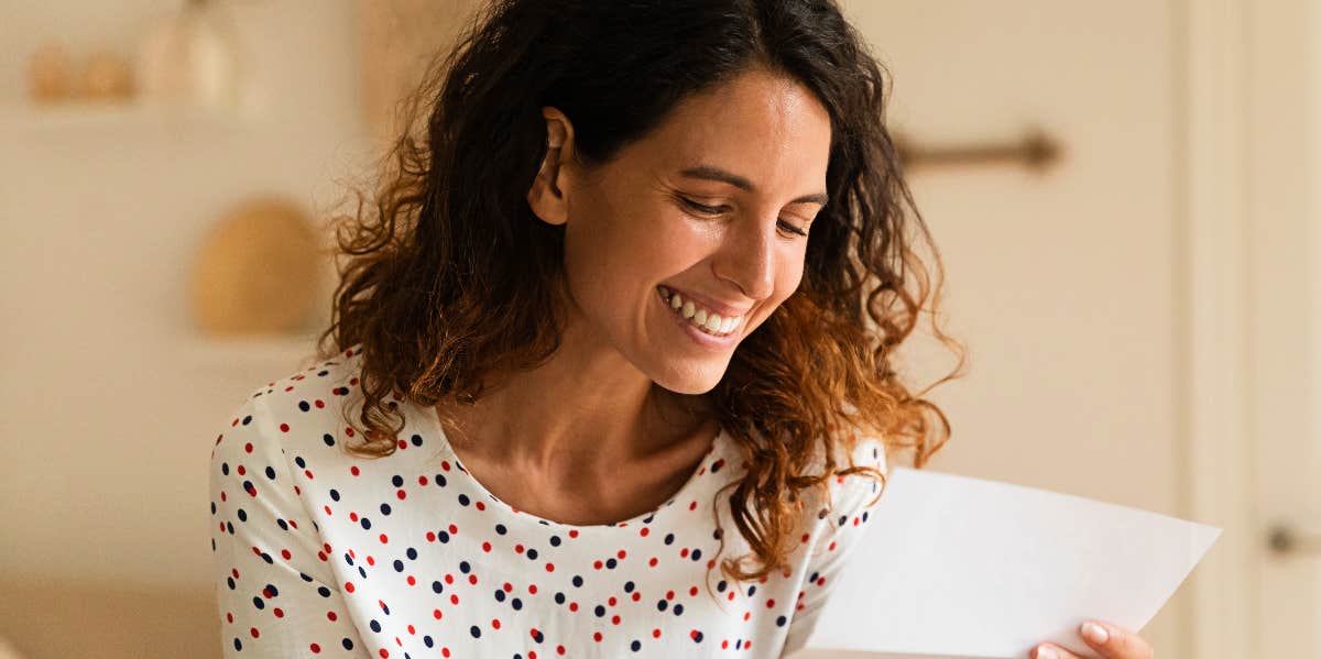Intimacy through writing letters Smiling woman reads a letter