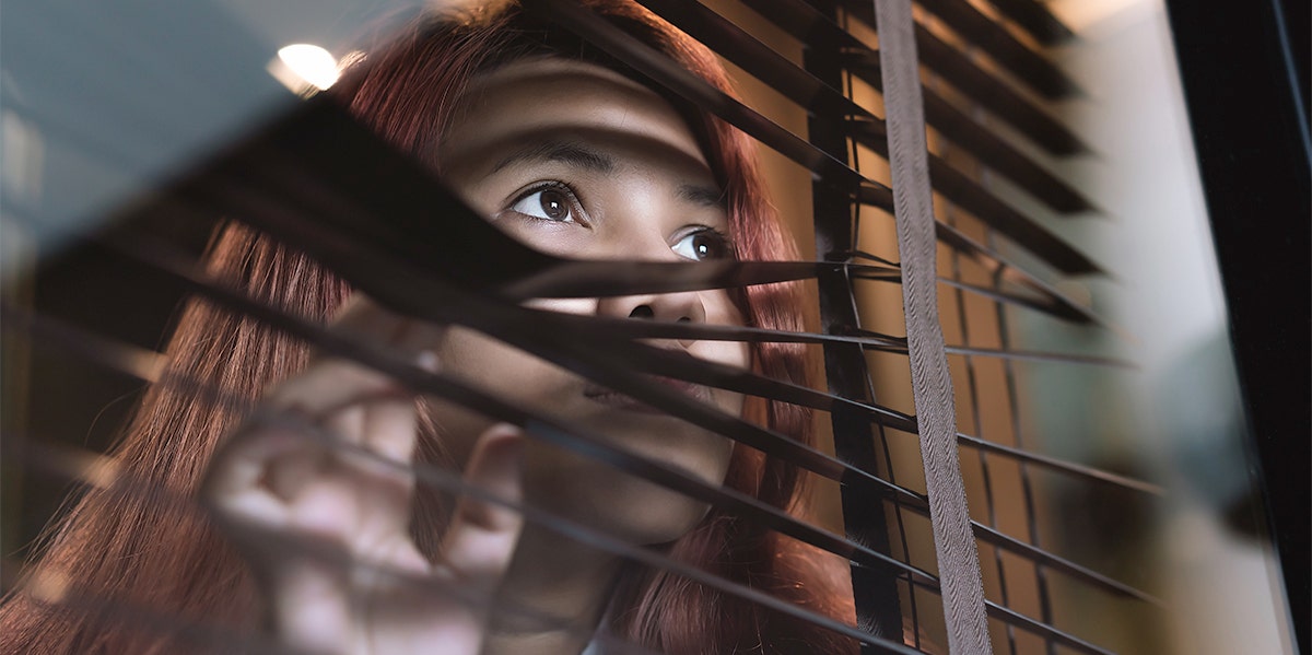 woman looking out window