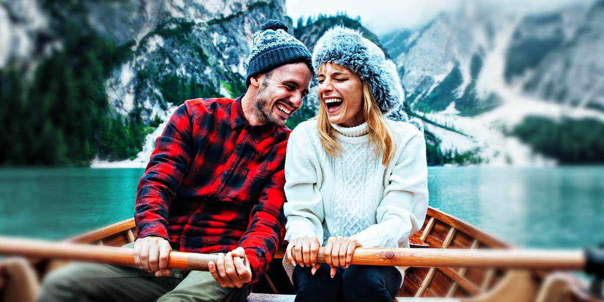 couple in a rowboat in a snowy canyon lake