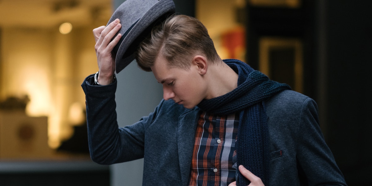 man taking off hat