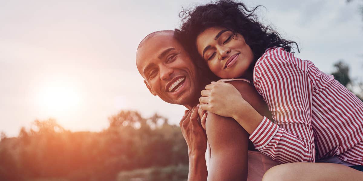 happy couple hugging in sunlight