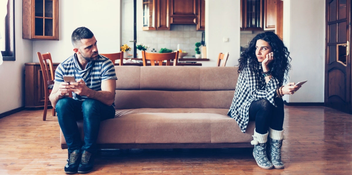 sad couple sitting on couch 