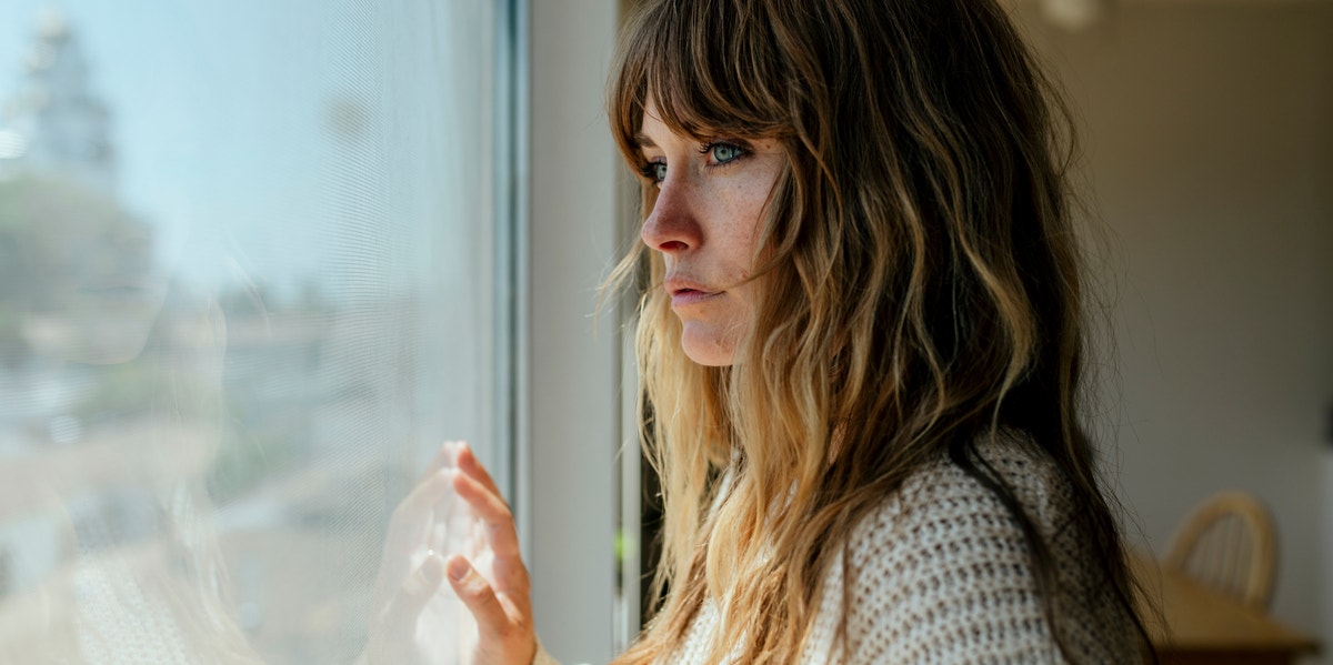 woman looking out window