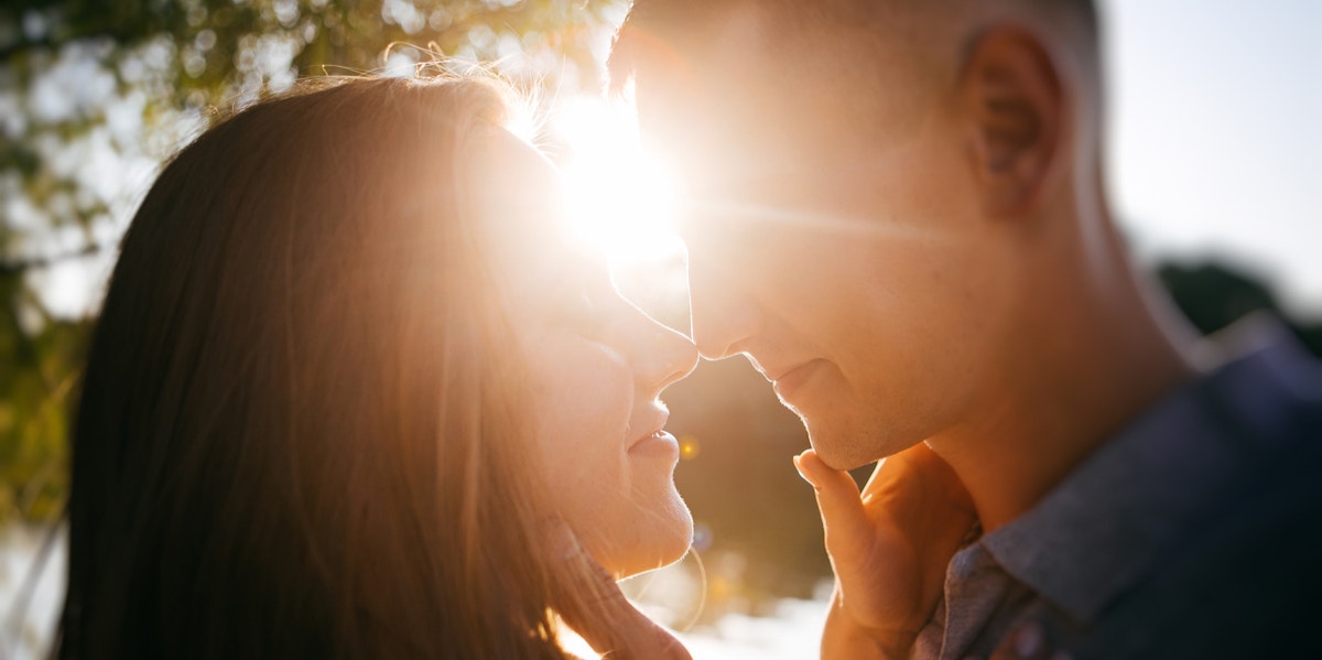 man and woman in front of sun