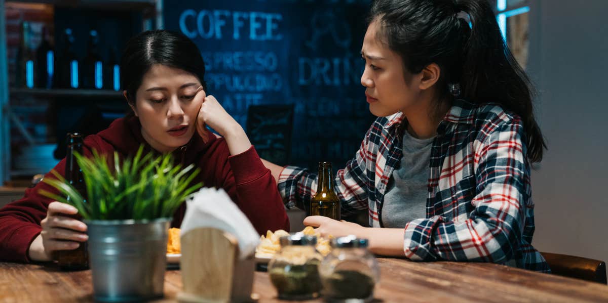 upset woman being comforted by friend