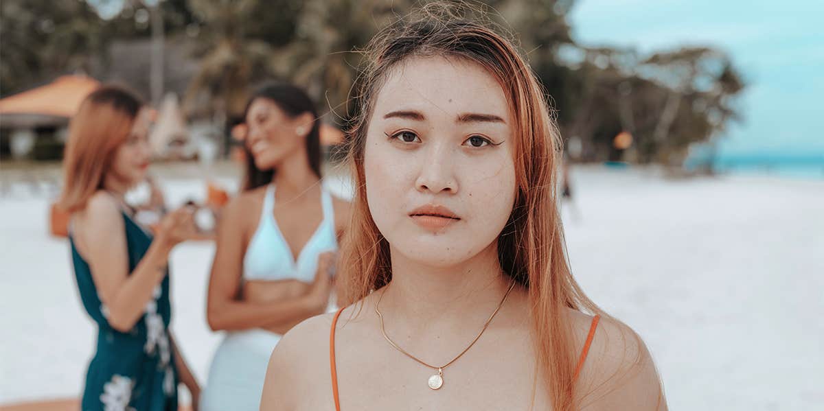 woman with two friends laughing behind her