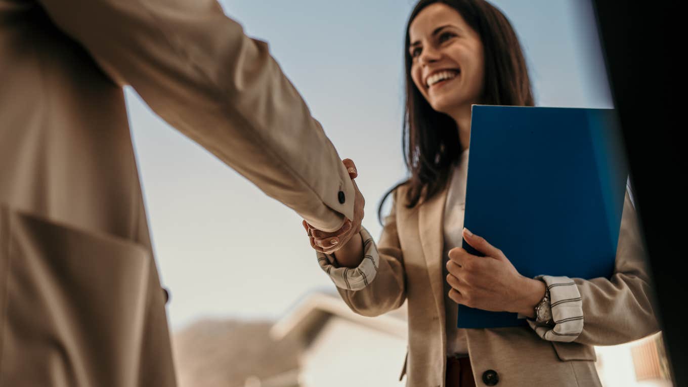 Job Seeker Finally Offered A Position Was Told She Had To Complete 18 Hours Of Unpaid Training woman shaking boss' hand after being offered a job
