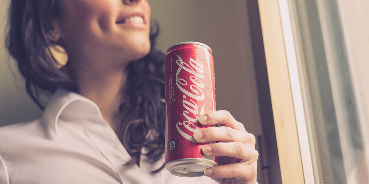 Just One Diet Coke Or Pepsi Max A Day Can Triple Your Risk Of Stroke woman holding coke