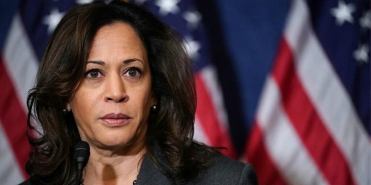 Who Are Kamala Harris's Parents, Shyamala Gopalan Harris And Donald Harris? kamala harris in front of american flag