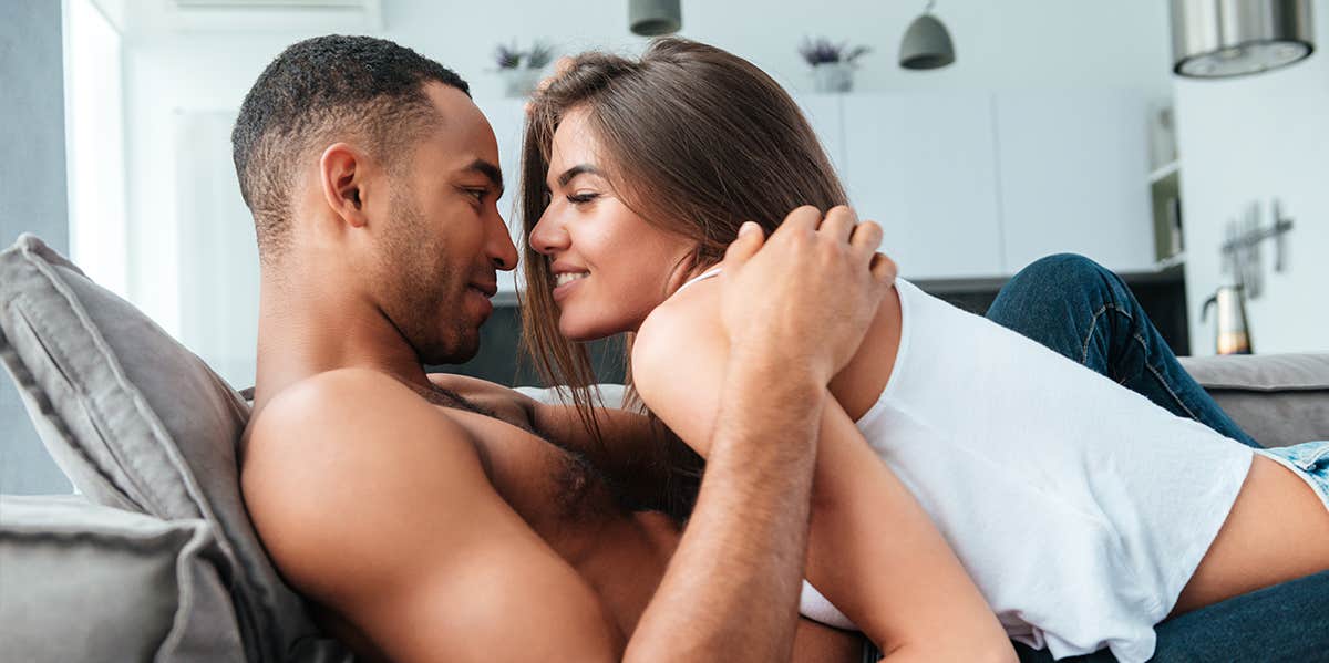 husband and wife snuggling together on couch