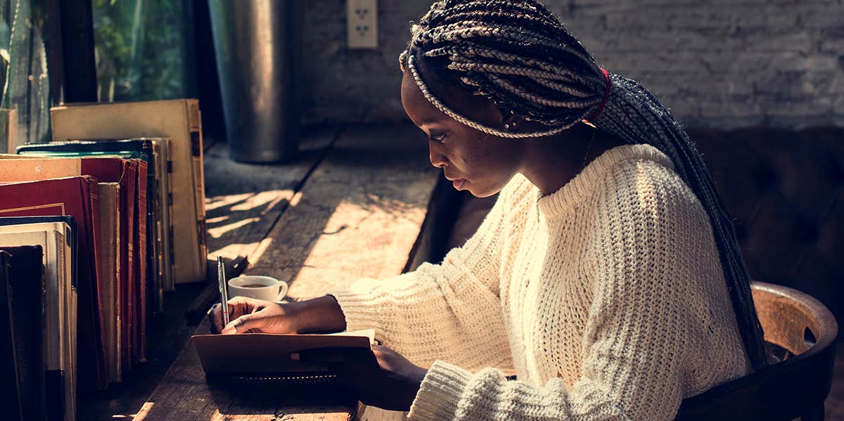 woman writing in journal