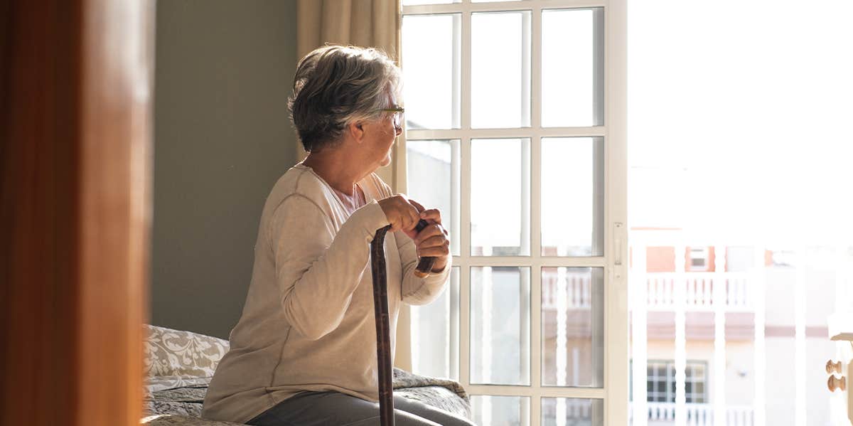 old woman sitting on bed