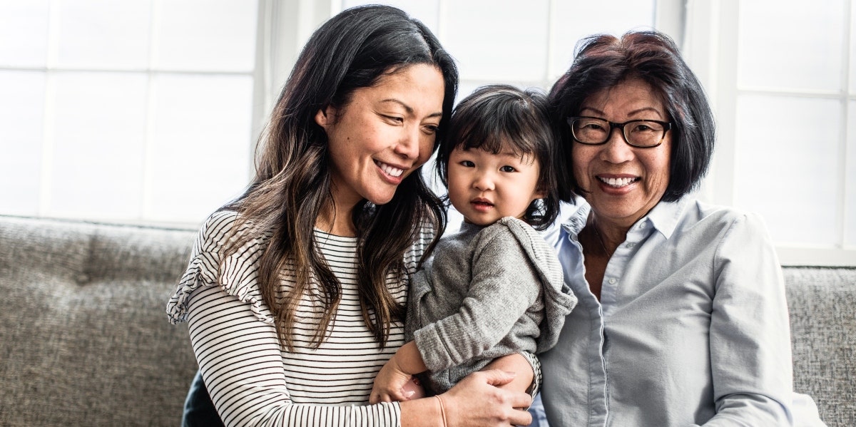 mom and grandmother holding child